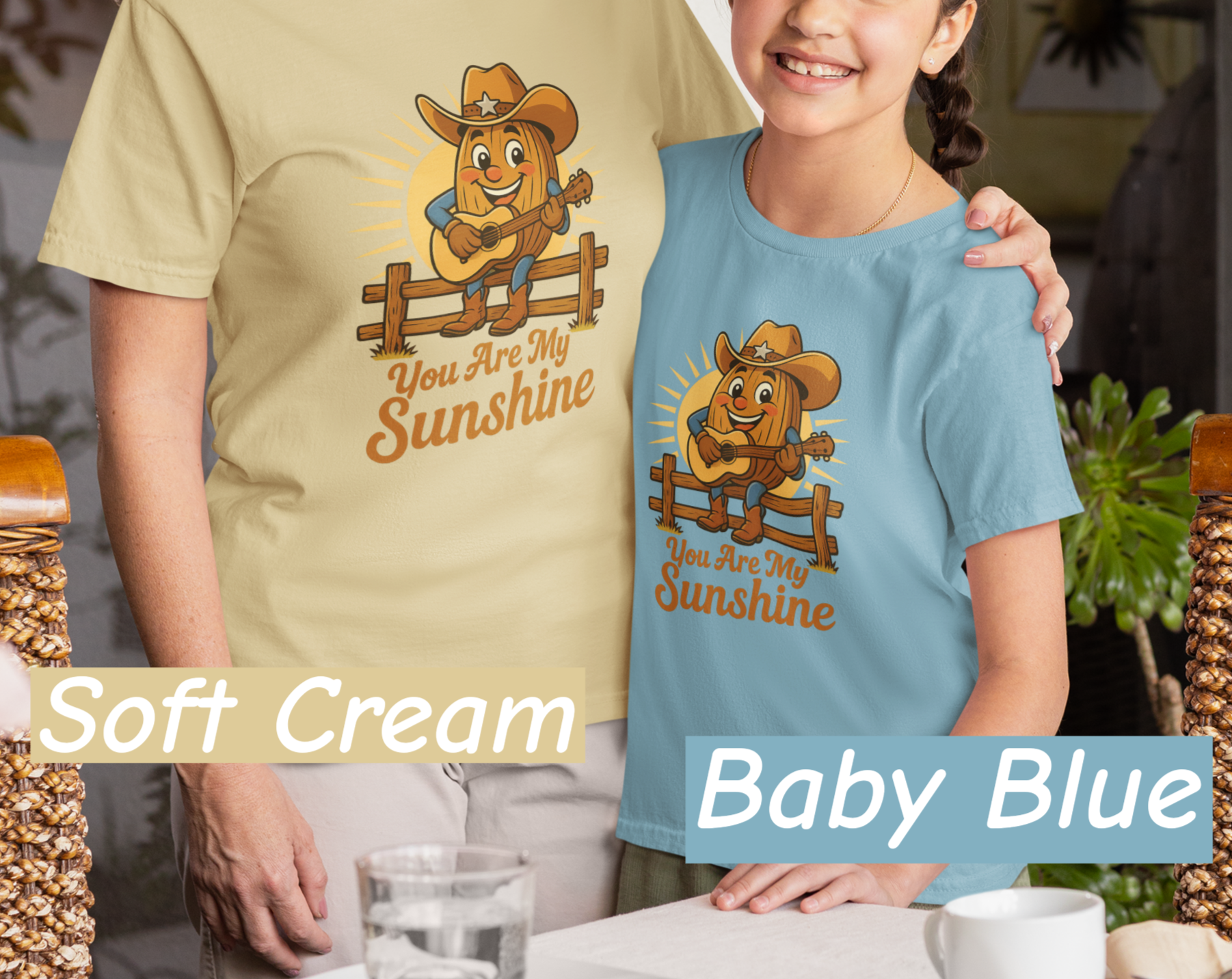 Mother and daughter wearing Bella+Canvas 3001 t-shirt with Pecan Pete singing cowboy design and the phrase You Are My Sunshine, vintage western style graphic tee.