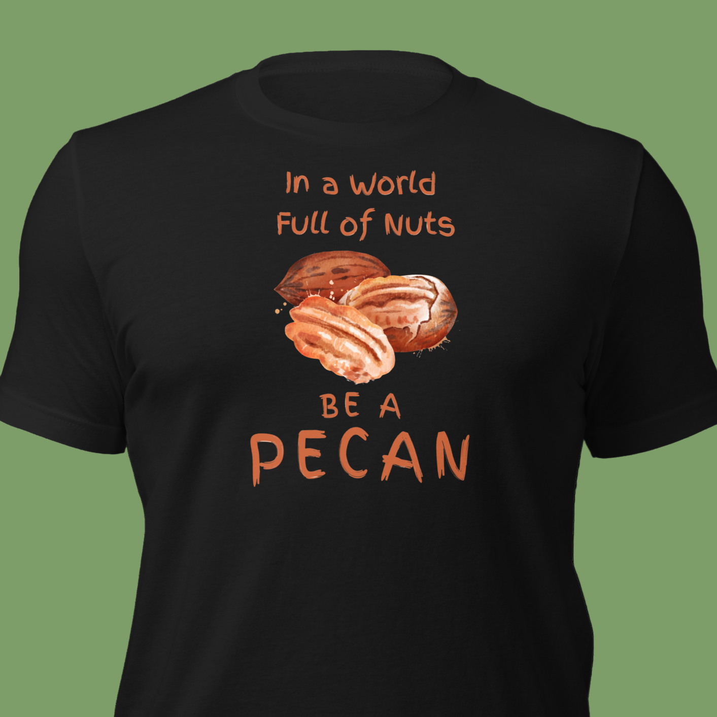 Cartoon-style Pecan Pete on a Bella+Canvas 3001C t-shirt with the slogan “In a world full of nuts, be a pecan.” A playful, humorous design celebrating pecans with a small NuttyMerch logo printed on the back near the neck.