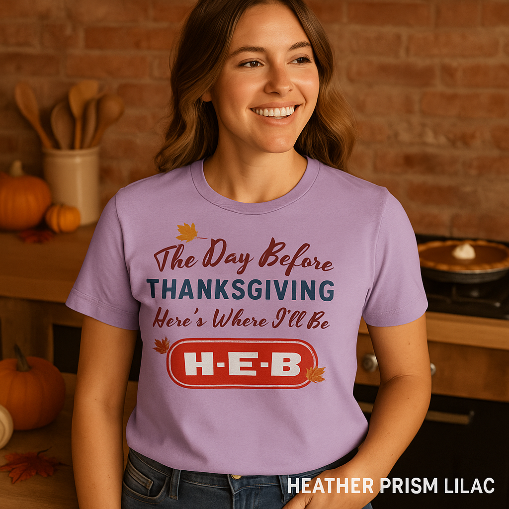 “Bella+Canvas 3001 Heather Prism Lilac t-shirt featuring NuttyMerch ‘Day Before Thanksgiving’ design, styled on a female model in a warm rustic kitchen with pie, pumpkins, and autumn leaves.”