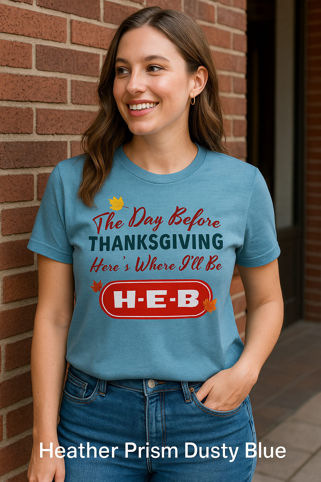 “Bella+Canvas 3001 Heater Prism Dusty Blue t-shirt featuring NuttyMerch ‘Day Before Thanksgiving’ design, styled on a female model in a warm rustic kitchen with pie, pumpkins, and autumn leaves.”.