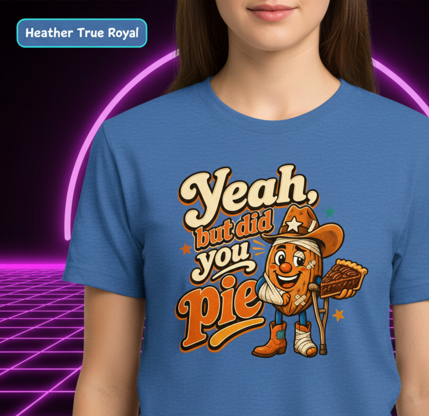 A person wearing a blue graphic T-shirt with a cartoon pie character and the text 'Yeah, but did you pie' on the front, shown against a neon purple grid background. A label in the top left reads 'Heather True Royal'.