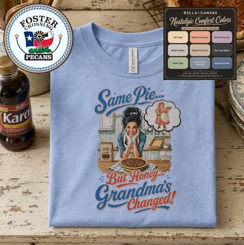 Bella+Canvas t-shirt displaying a graphic of a modern, stylish grandma in a kitchen reflecting on traditional grandmas, with retro typography reading "Same Pie, Grandma's Changed".