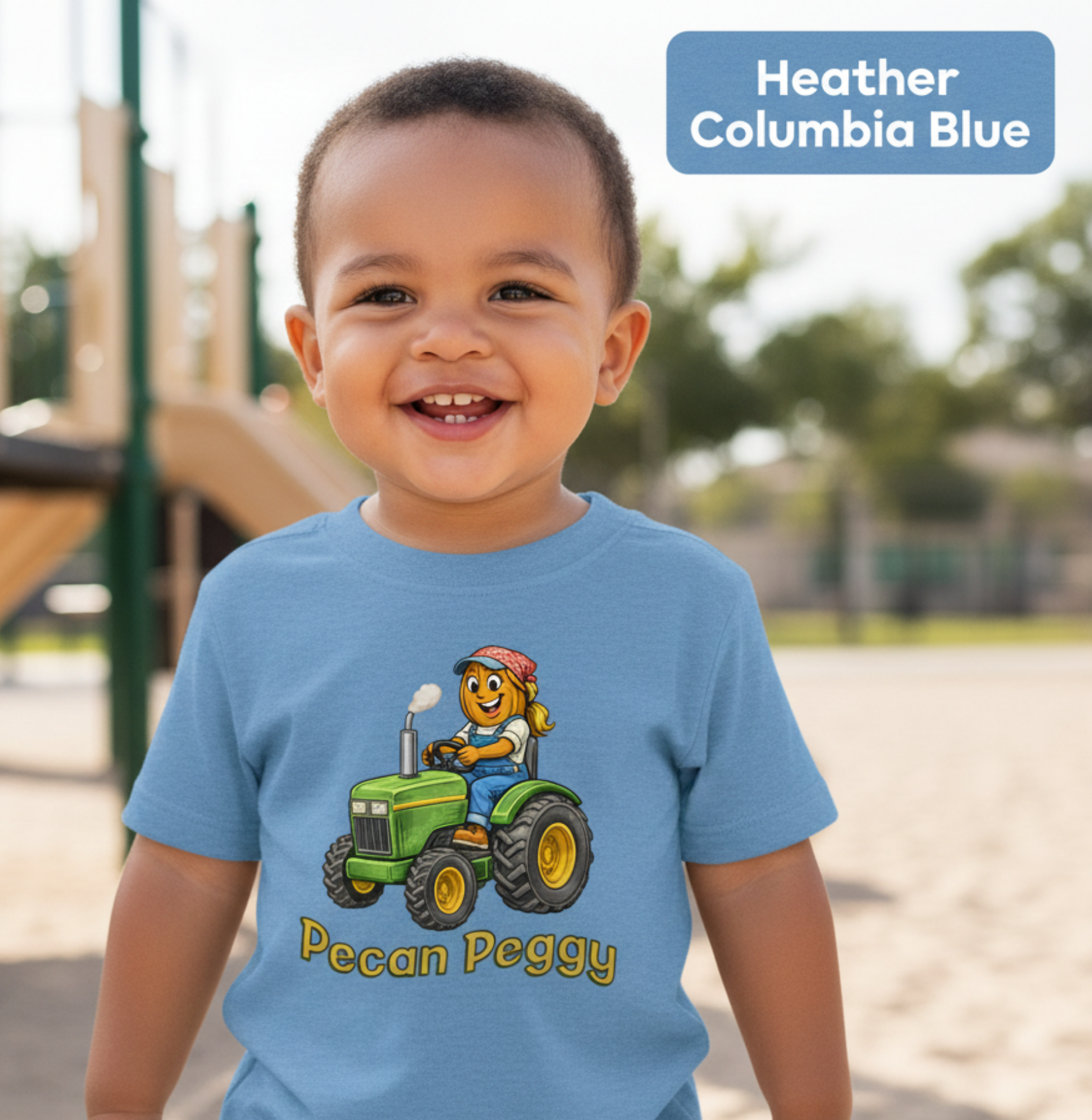 Child wearing a blue t-shirt with a cartoon character of Pecan Peggy on a green tractor at a playground