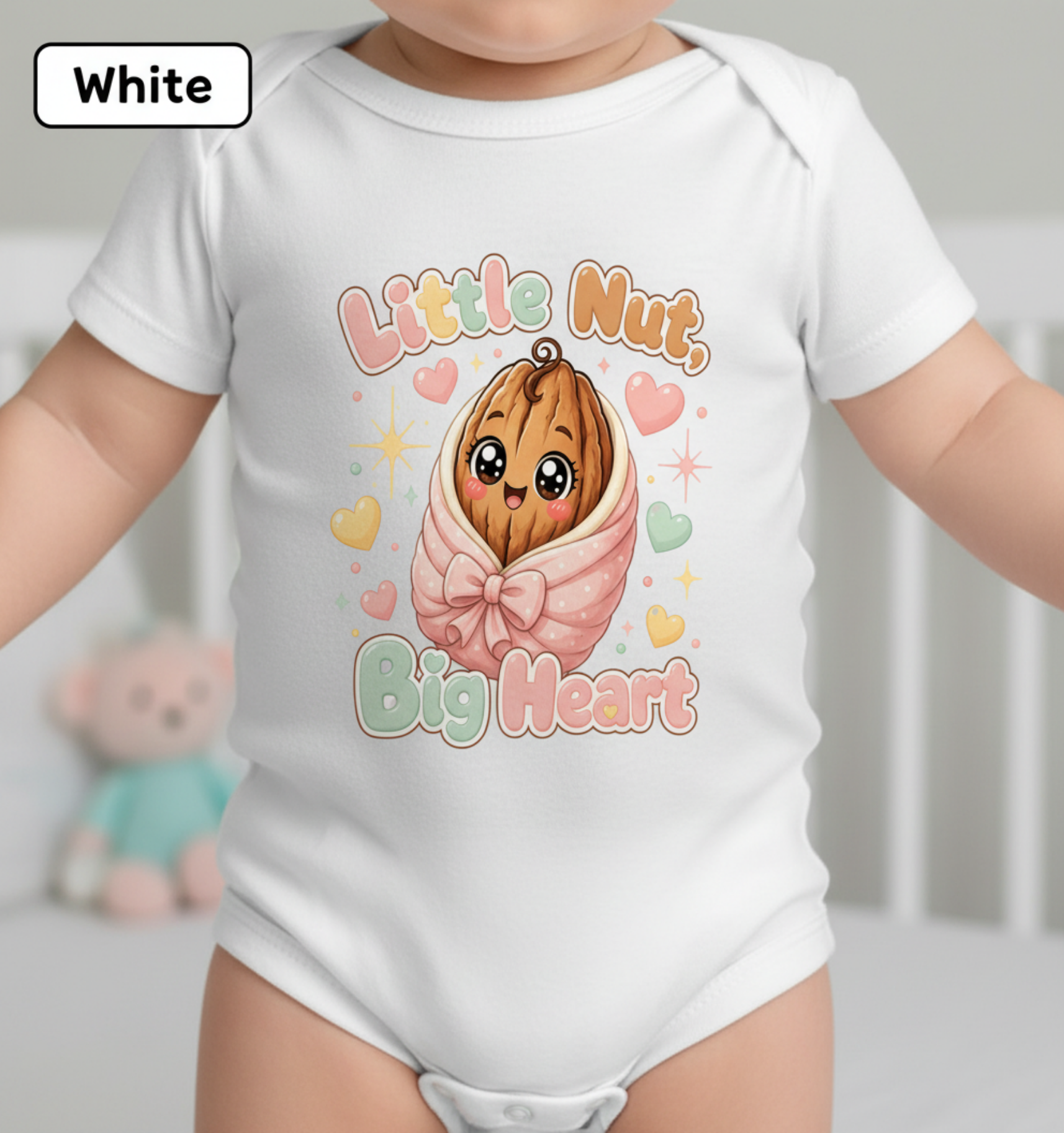 White short-sleeve baby bodysuit with a cute cartoon nut graphic and the words 'Little Nut, Big Heart' on the front, shown on a baby. A small 'White' label appears in the top-left corner.