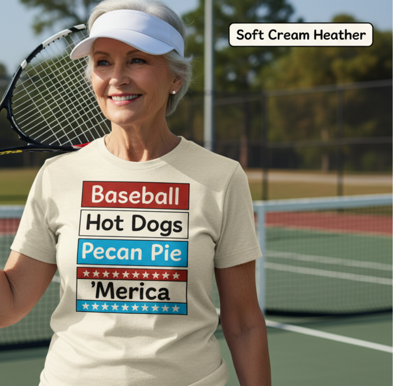 Woman on a tennis court wearing a t-shirt with patriotic text, holding a tennis racket.