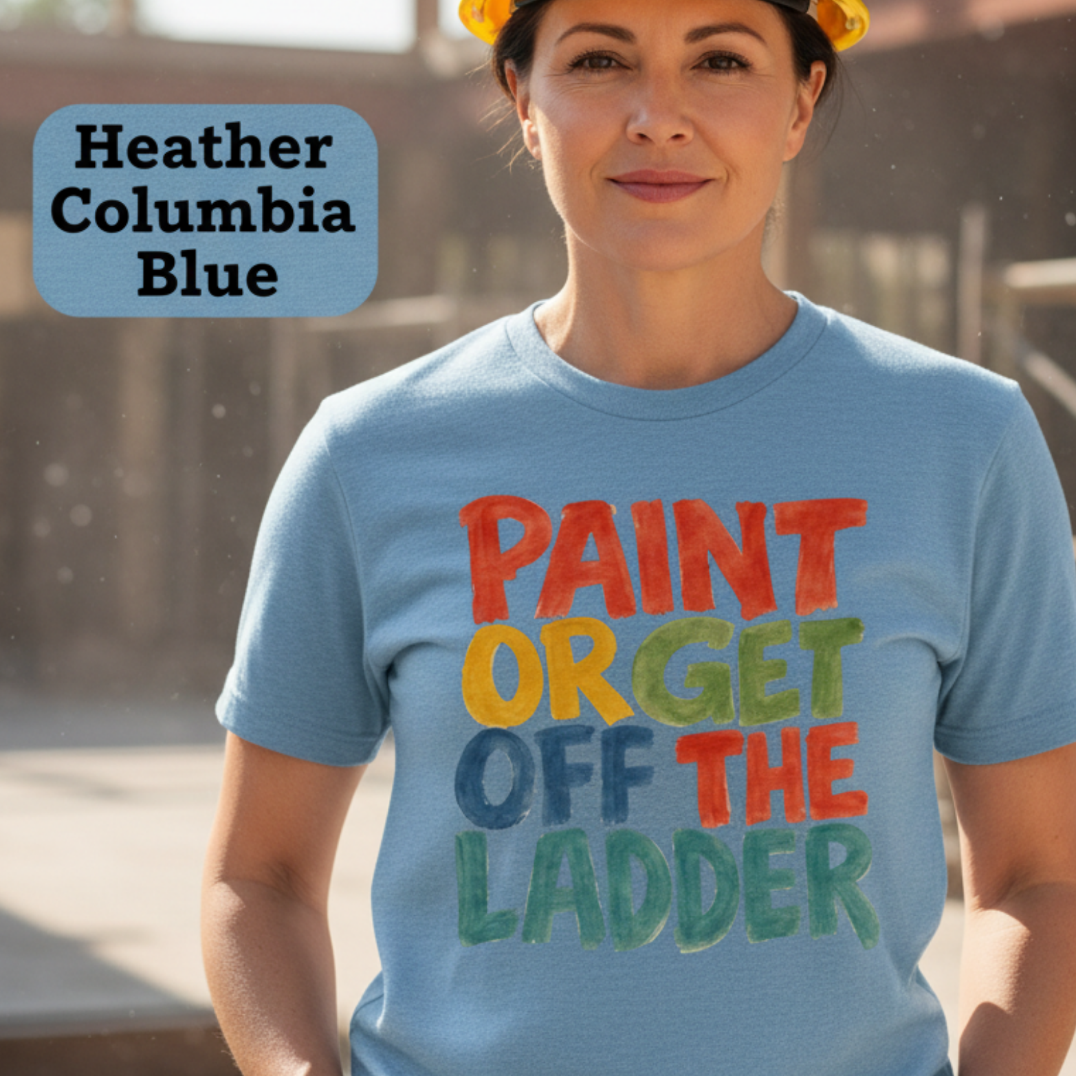Person wearing a blue t-shirt with colorful text at a construction site