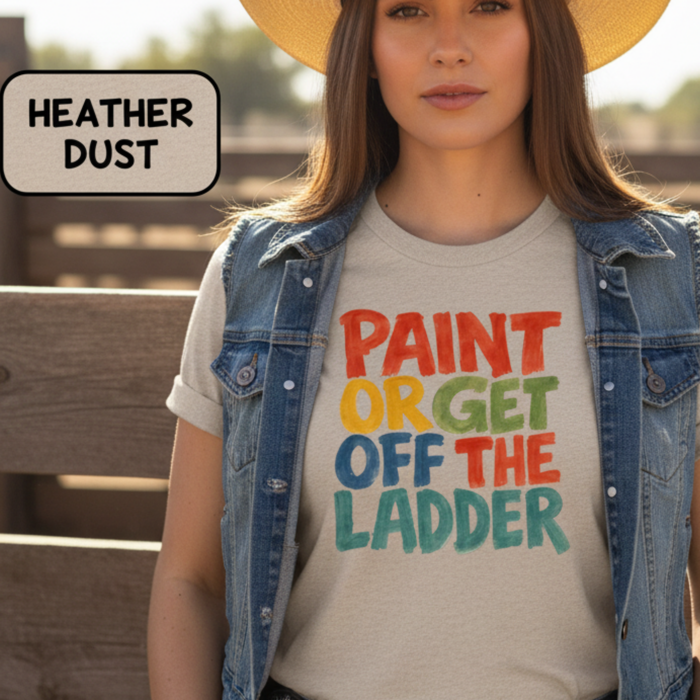 Cowgirl wearing a t-shirt with colorful text and a cowboy hat in a rustic setting