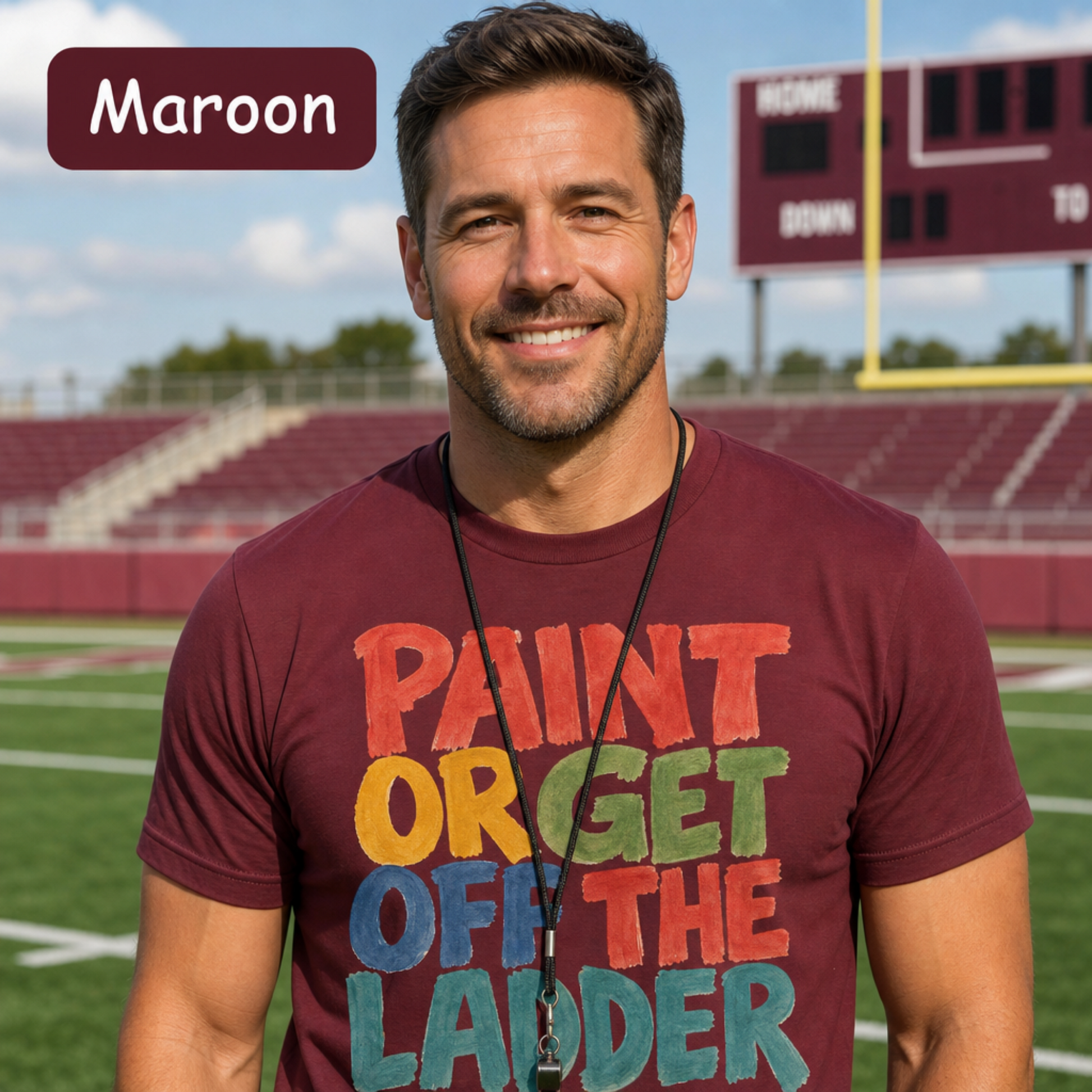 Coach wearing a maroon t-shirt with colorful text on a football field