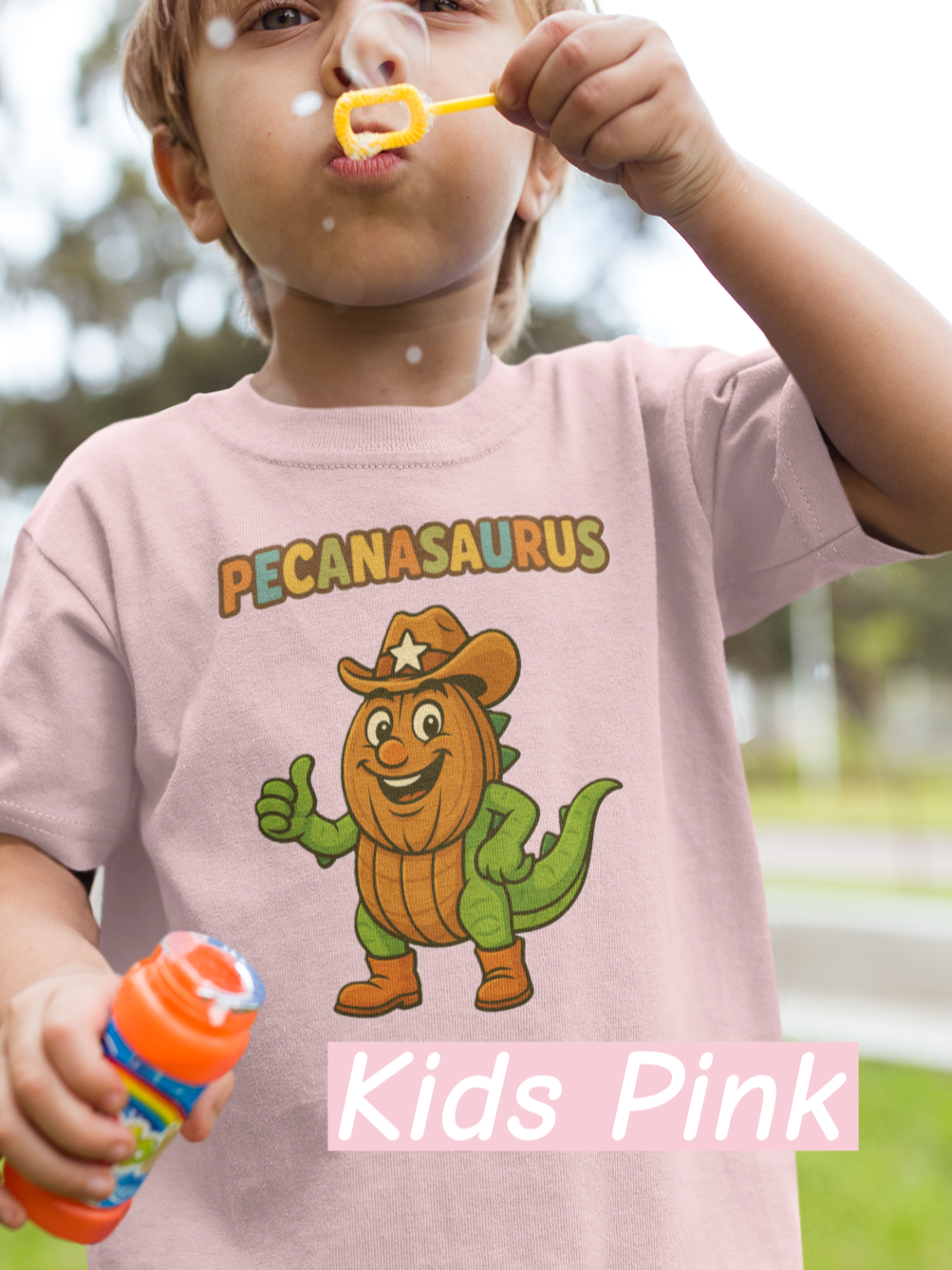 “Pink curved ‘Pecanasaurus’ text in playful multicolor letters designed for a kids dinosaur-themed t-shirt.”
