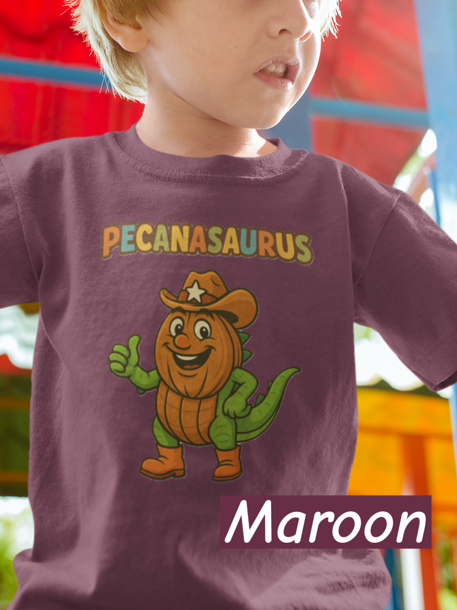 “Maroon curved ‘Pecanasaurus’ text in playful multicolor letters designed for a kids dinosaur-themed t-shirt.”