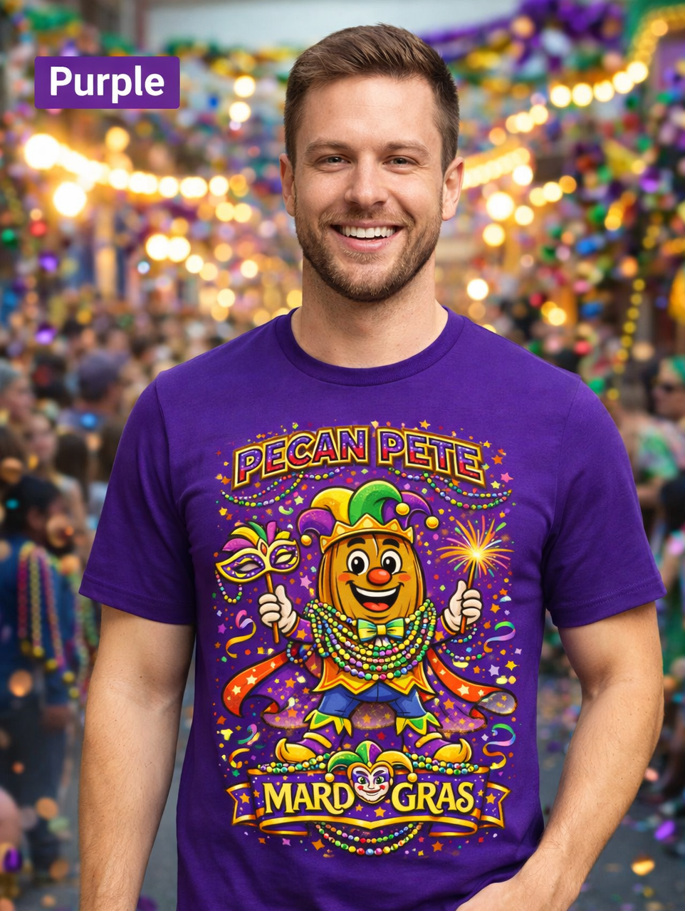 Smiling model wearing a colorful Mardi Gras Pecan Pete graphic T-shirt, featuring a festive jester pecan character with beads, mask, sparkler, and parade confetti, photographed against a lively Mardi Gras celebration background.