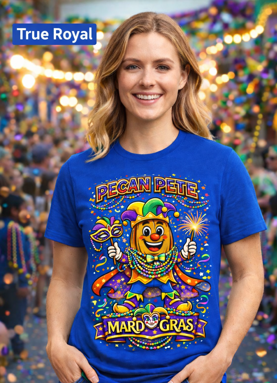 Smiling model wearing a colorful Mardi Gras Pecan Pete graphic T-shirt, featuring a festive jester pecan character with beads, mask, sparkler, and parade confetti, photographed against a lively Mardi Gras celebration background.