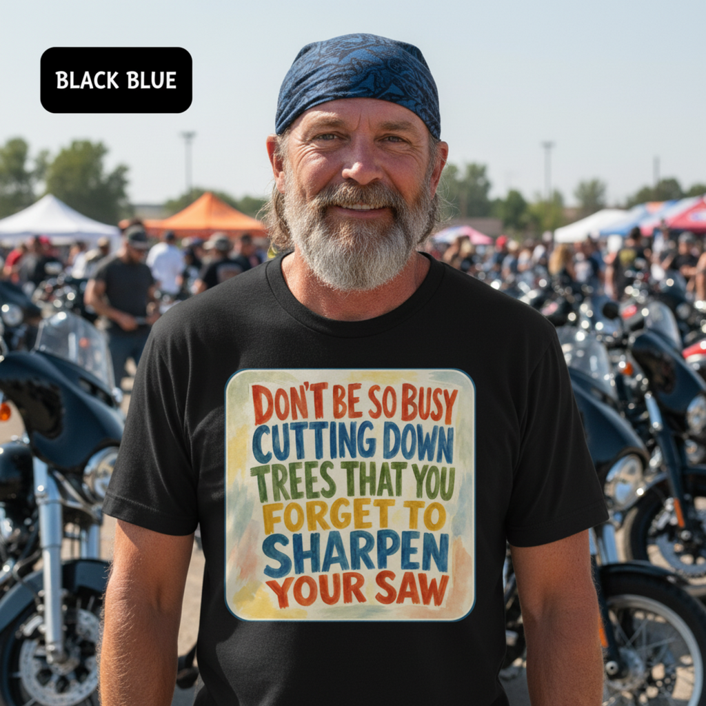 Man wearing a black t-shirt with a colorful graphic and text at a motorcycle event. don't be so busy cutting down trees that you forget to sharpen your saw