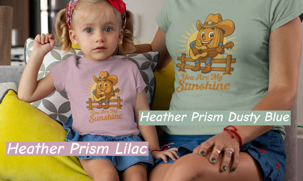 Mother and daughter wearing Bella+Canvas 3001 t-shirt with Pecan Pete singing cowboy design and the phrase You Are My Sunshine, vintage western style graphic tee