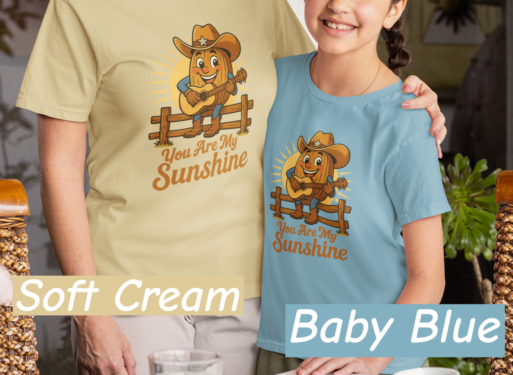 Mother and daughter wearing Bella+Canvas 3001 t-shirt with Pecan Pete singing cowboy design and the phrase You Are My Sunshine, vintage western style graphic tee.