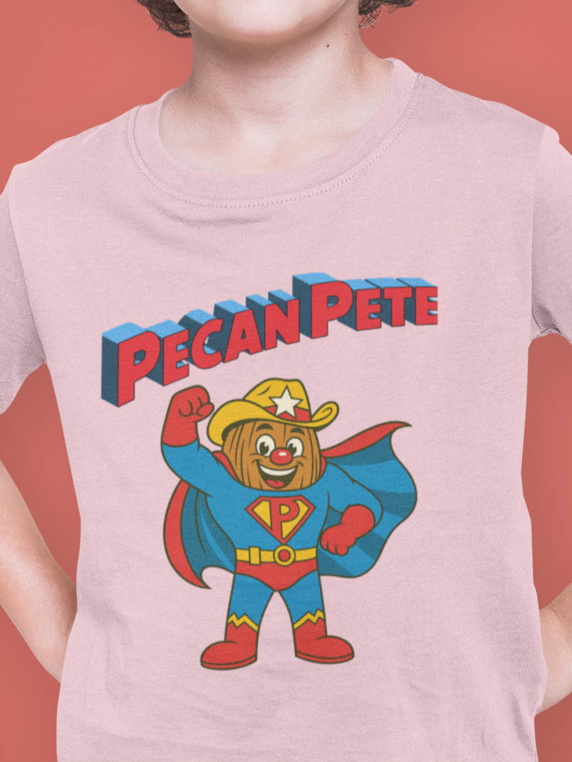 “Cartoon superhero Pecan Pete in blue and red costume with cape and cowboy hat on NuttyMerch youth tee – retro comic style superhero design.”