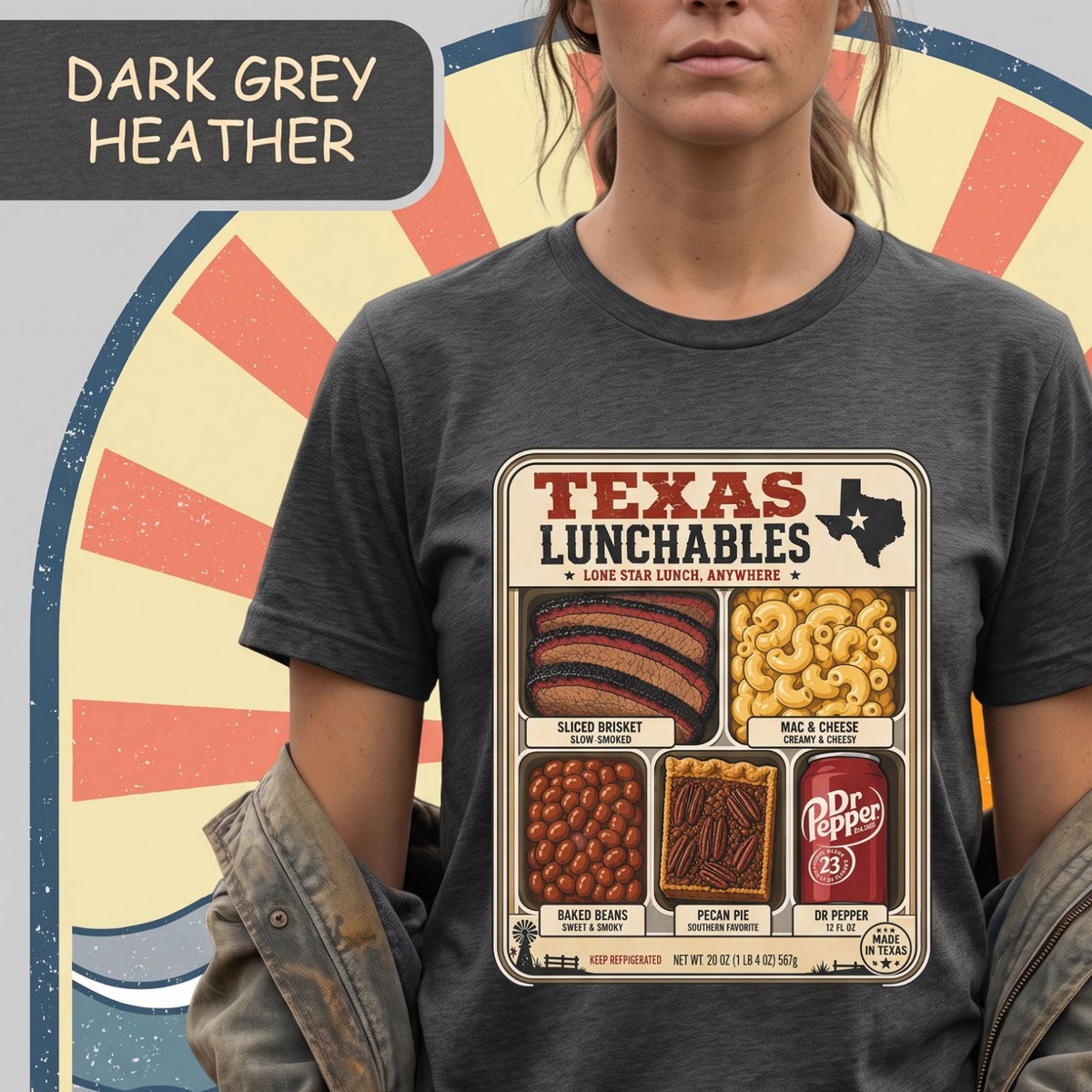 Vintage-style "Texas Lunchables" graphic tee illustrating a classic Texan BBQ meal with brisket, mac and cheese, pecan pie, beans, and a soft drink.