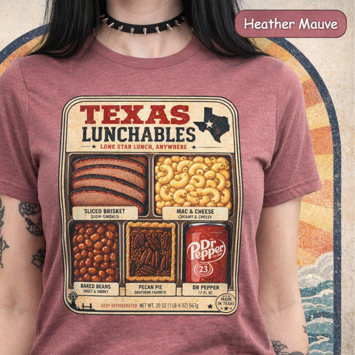 Vintage-style "Texas Lunchables" graphic tee illustrating a classic Texan BBQ meal with brisket, mac and cheese, pecan pie, beans, and a soft drink.