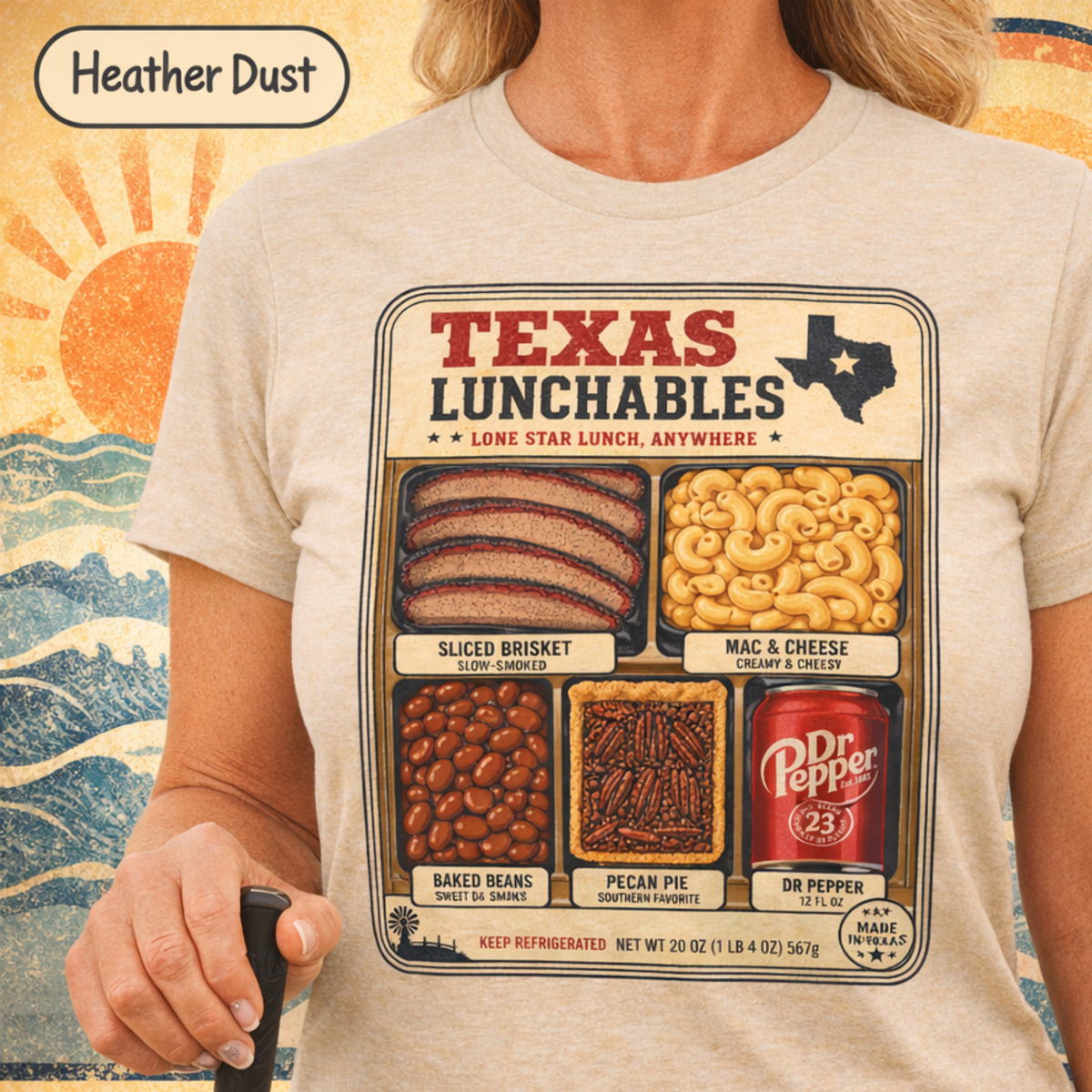Vintage-style "Texas Lunchables" graphic tee illustrating a classic Texan BBQ meal with brisket, mac and cheese, pecan pie, beans, and a soft drink.