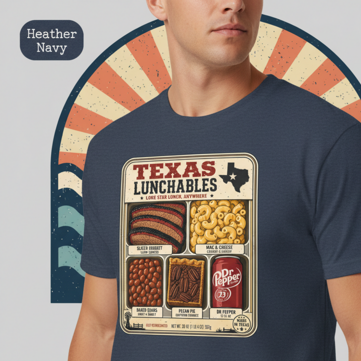 Vintage-style "Texas Lunchables" graphic tee illustrating a classic Texan BBQ meal with brisket, mac and cheese, pecan pie, beans, and a soft drink.