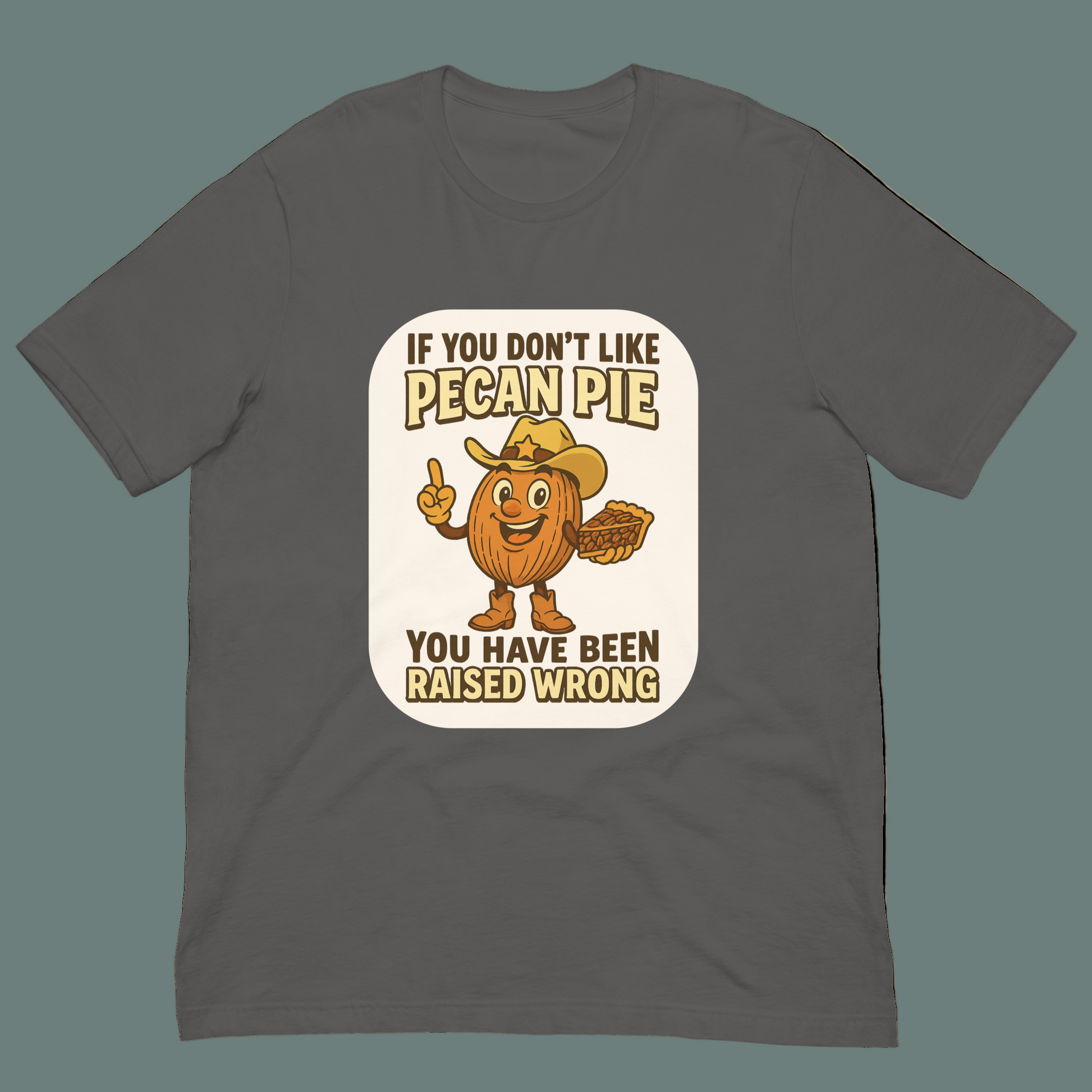 Bella+Canvas 3001U t-shirt made in USA featuring cartoon pecan cowboy holding pie with text ‘If you don’t like pecan pie, you have been raised wrong.’