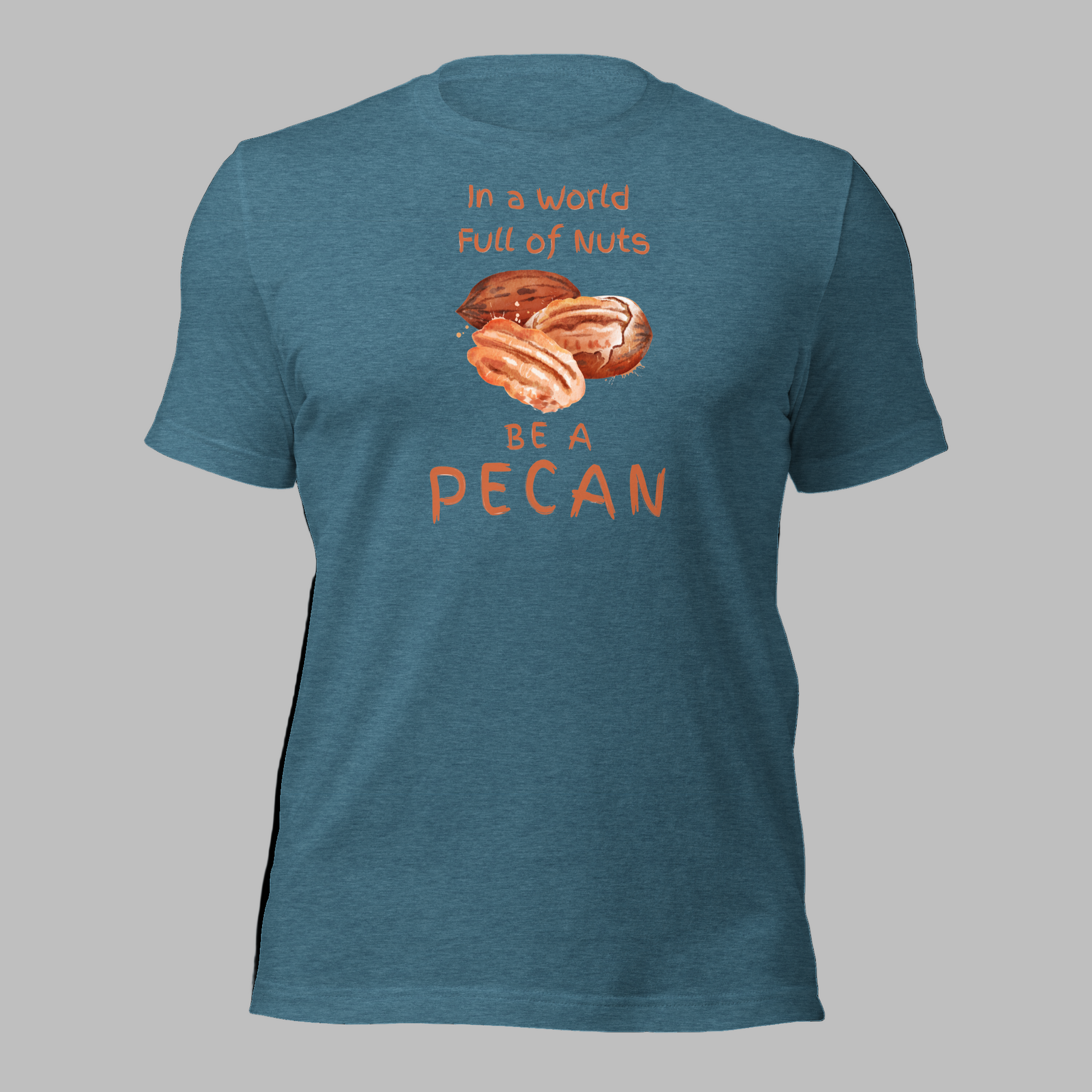 Cartoon-style Pecan Pete on a Bella+Canvas 3001C t-shirt with the slogan “In a world full of nuts, be a pecan.” A playful, humorous design celebrating pecans with a small NuttyMerch logo printed on the back near the neck.