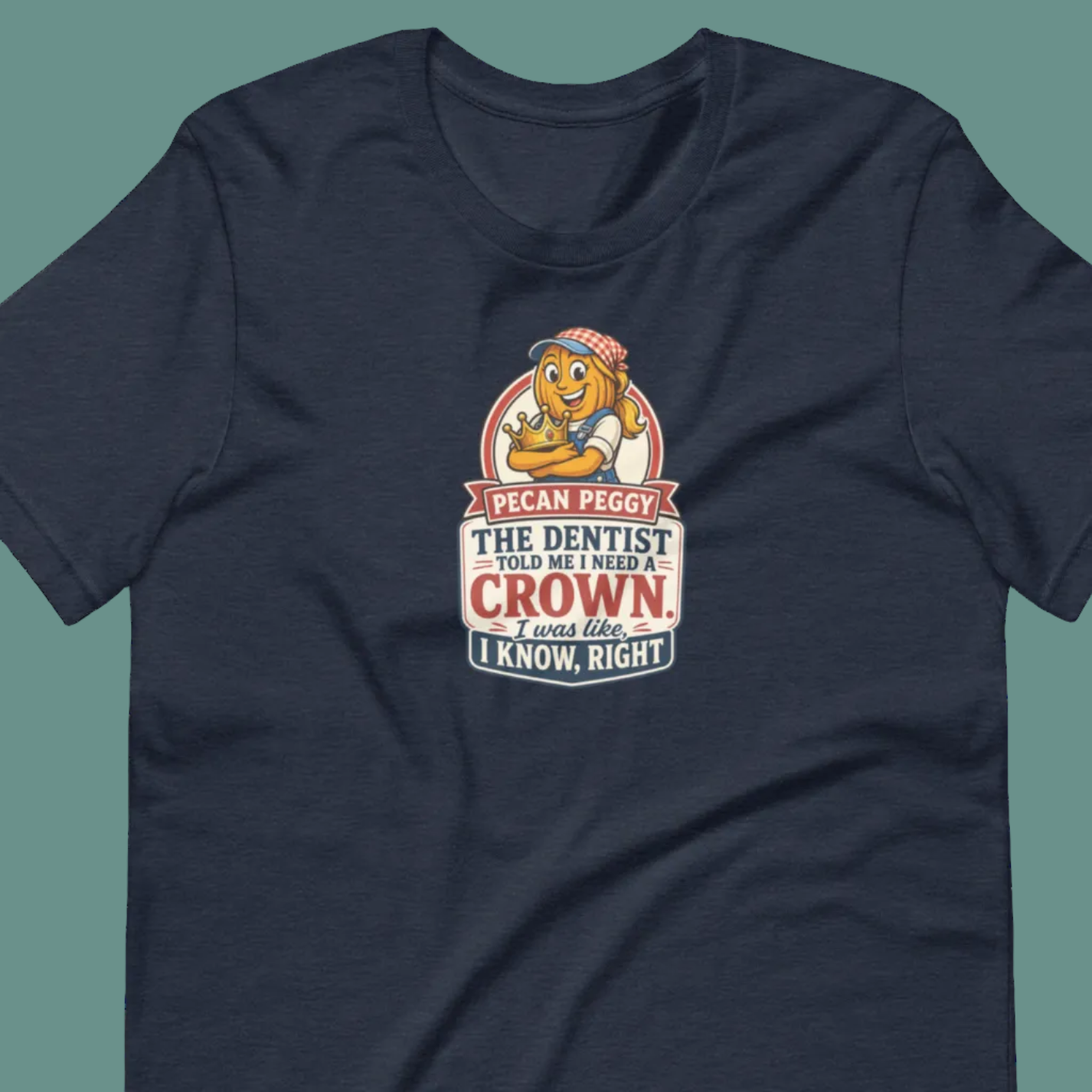 A navy blue short-sleeve crewneck t-shirt featuring a cartoon graphic of a lion wearing a dental mask and hat, with the text 'PICAN PEGGY THE DENTIST WANTS MY CROWN. I KNOW THAT, RIGHT?'.
