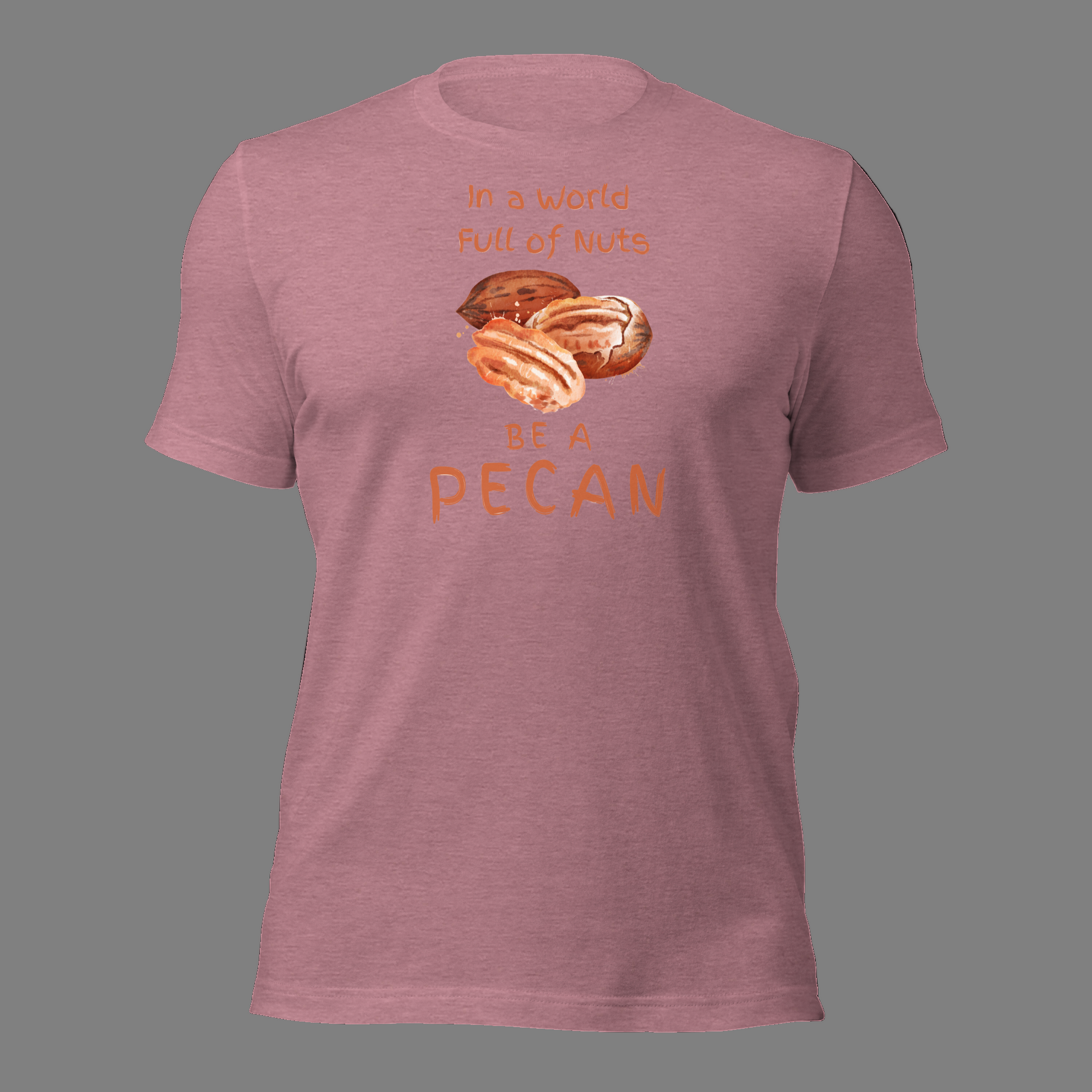 Cartoon-style Pecan Pete on a Bella+Canvas 3001C t-shirt with the slogan “In a world full of nuts, be a pecan.” A playful, humorous design celebrating pecans with a small NuttyMerch logo printed on the back near the neck.