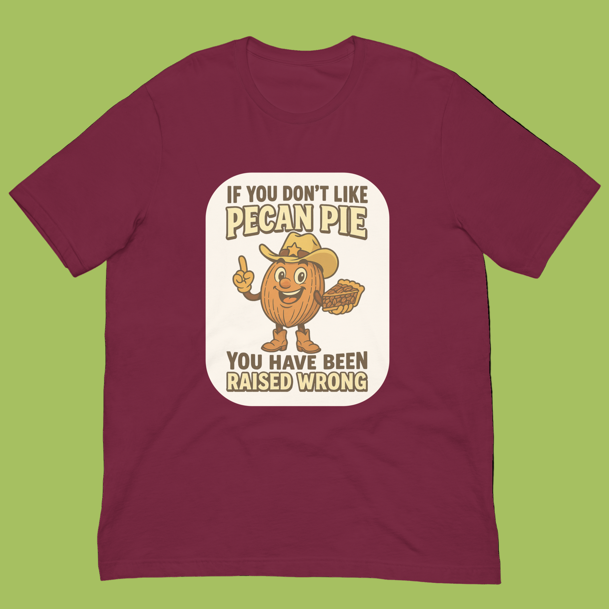 Bella+Canvas 3001U t-shirt made in USA featuring cartoon pecan cowboy holding pie with text ‘If you don’t like pecan pie, you have been raised wrong.’