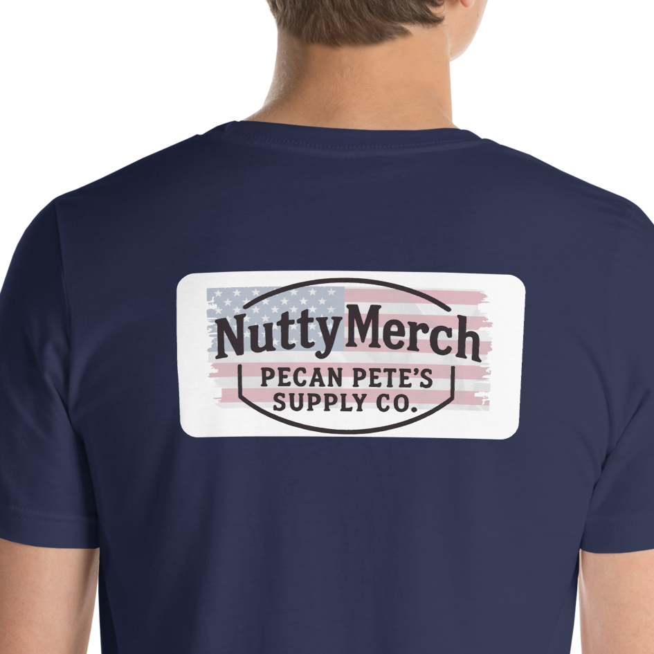 “Patriotic Pecan Pete cartoon character holding American flag and sparklers, wearing red white and blue hat on graphic t shirt celebrating America 250 in retro Americana style.