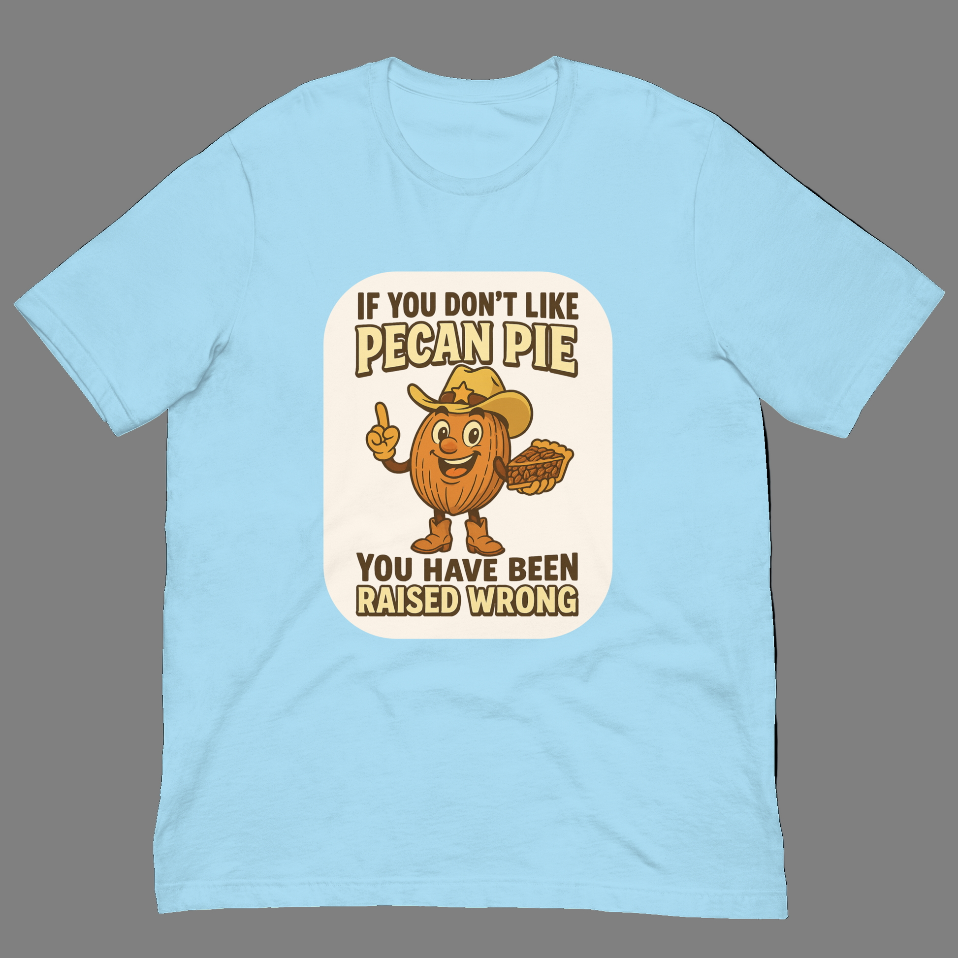 Bella+Canvas 3001U t-shirt made in USA featuring cartoon pecan cowboy holding pie with text ‘If you don’t like pecan pie, you have been raised wrong.’