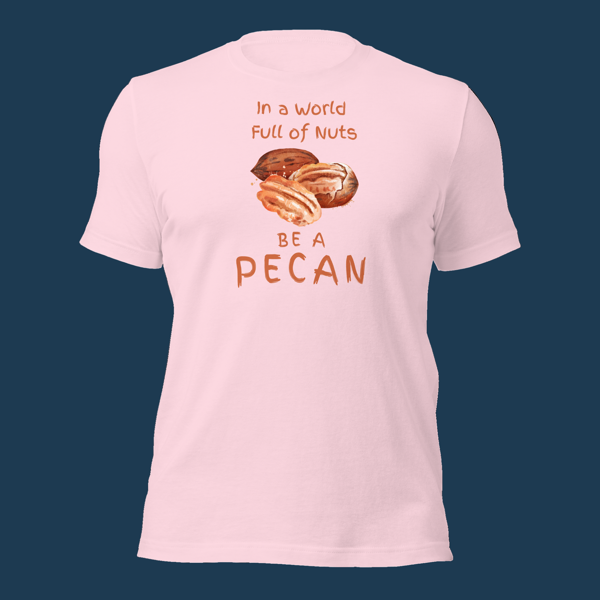 Cartoon-style Pecan Pete on a Bella+Canvas 3001C t-shirt with the slogan “In a world full of nuts, be a pecan.” A playful, humorous design celebrating pecans with a small NuttyMerch logo printed on the back near the neck.