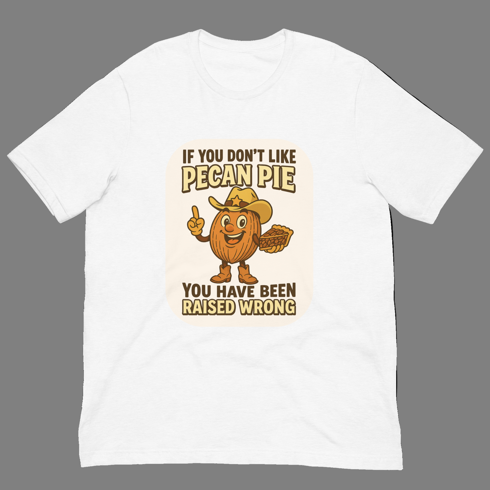 Bella+Canvas 3001U t-shirt made in USA featuring cartoon pecan cowboy holding pie with text ‘If you don’t like pecan pie, you have been raised wrong.’