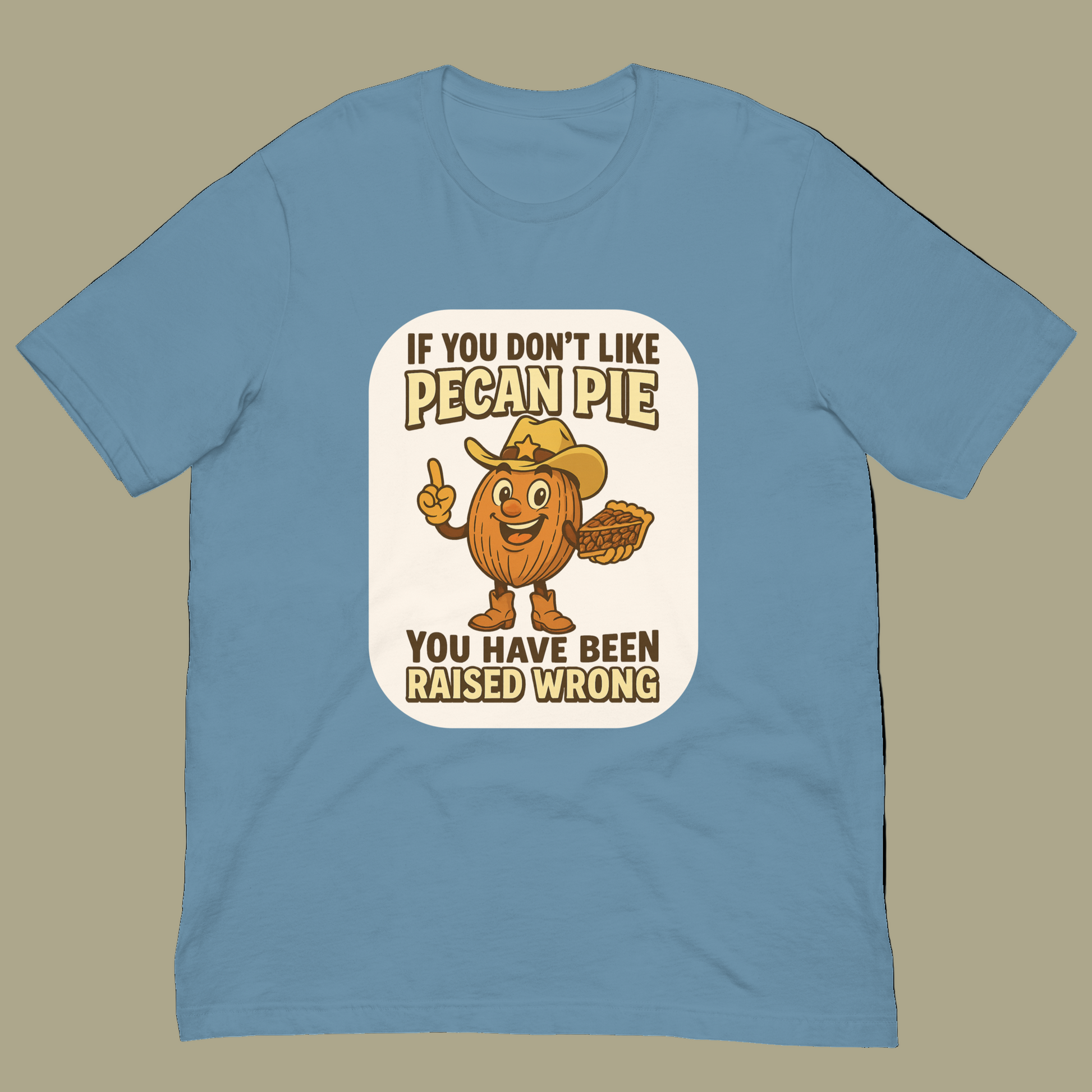 Bella+Canvas 3001U t-shirt made in USA featuring cartoon pecan cowboy holding pie with text ‘If you don’t like pecan pie, you have been raised wrong.’